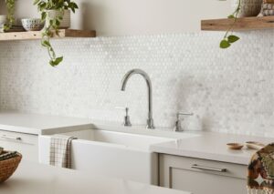 White and gray marble peel-and-stick mosaic backsplash in a minimalist boho kitchen